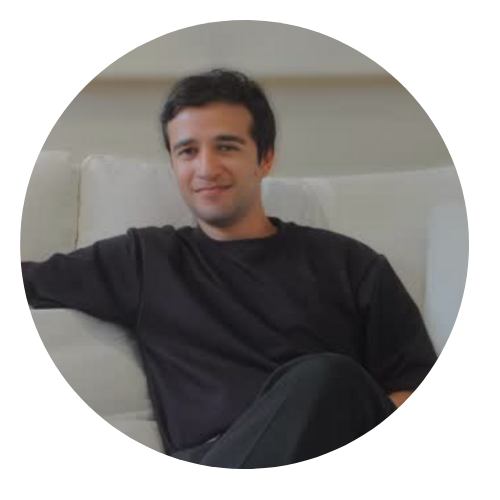 Man sitting on a white couch wearing a black shirt