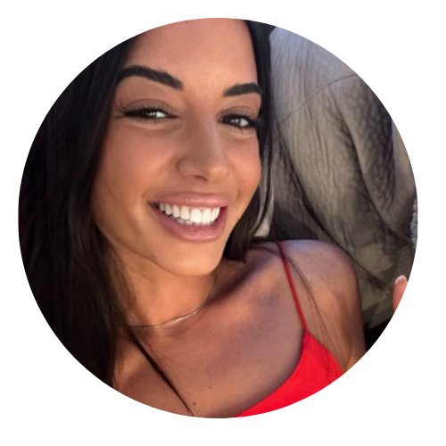 Gorgeous female furniture designer with a big smile wearing a red top, with a blurred background