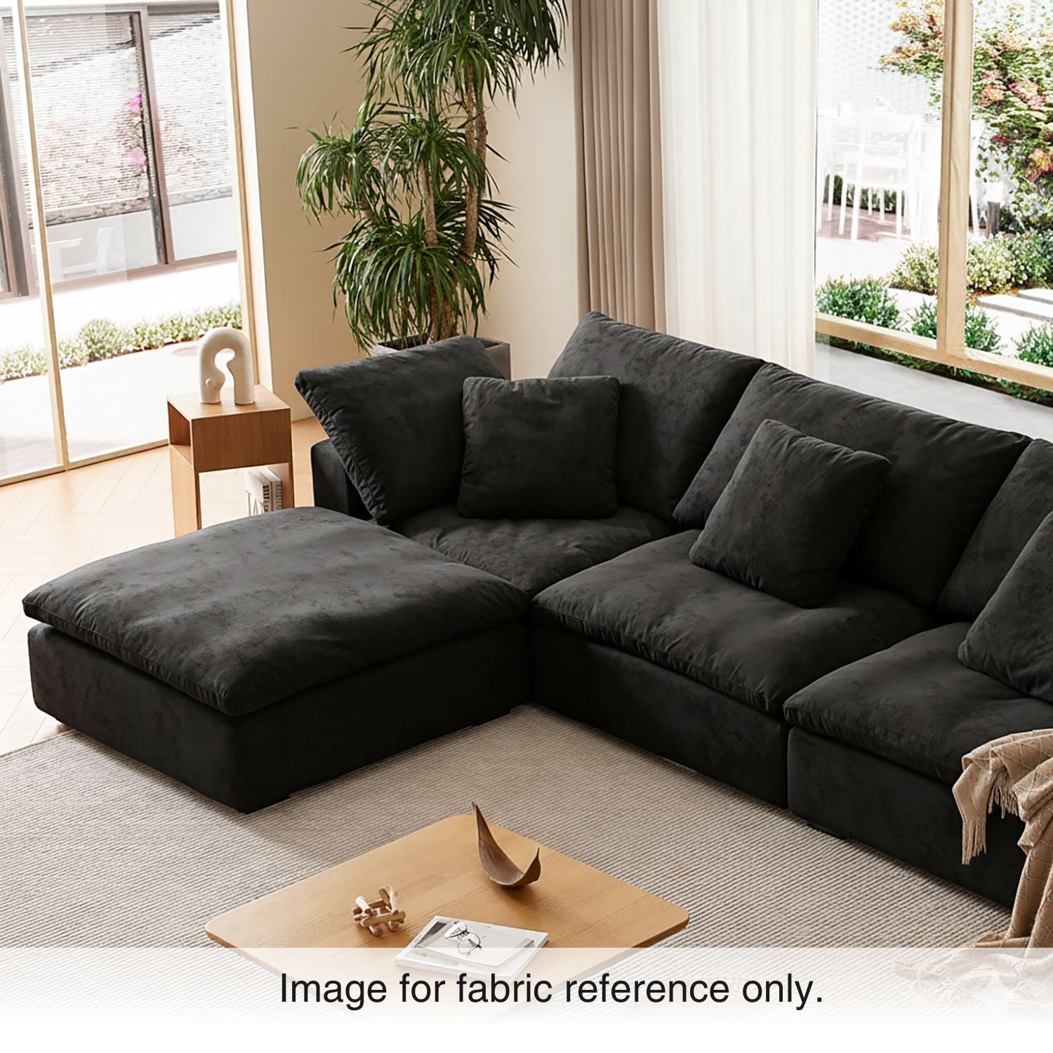Black velvet modular couch with plush charcoal upholstery and deep seating, styled in a contemporary interior from the Tivoli Velvet Sofa Collection by Mario Capasa.