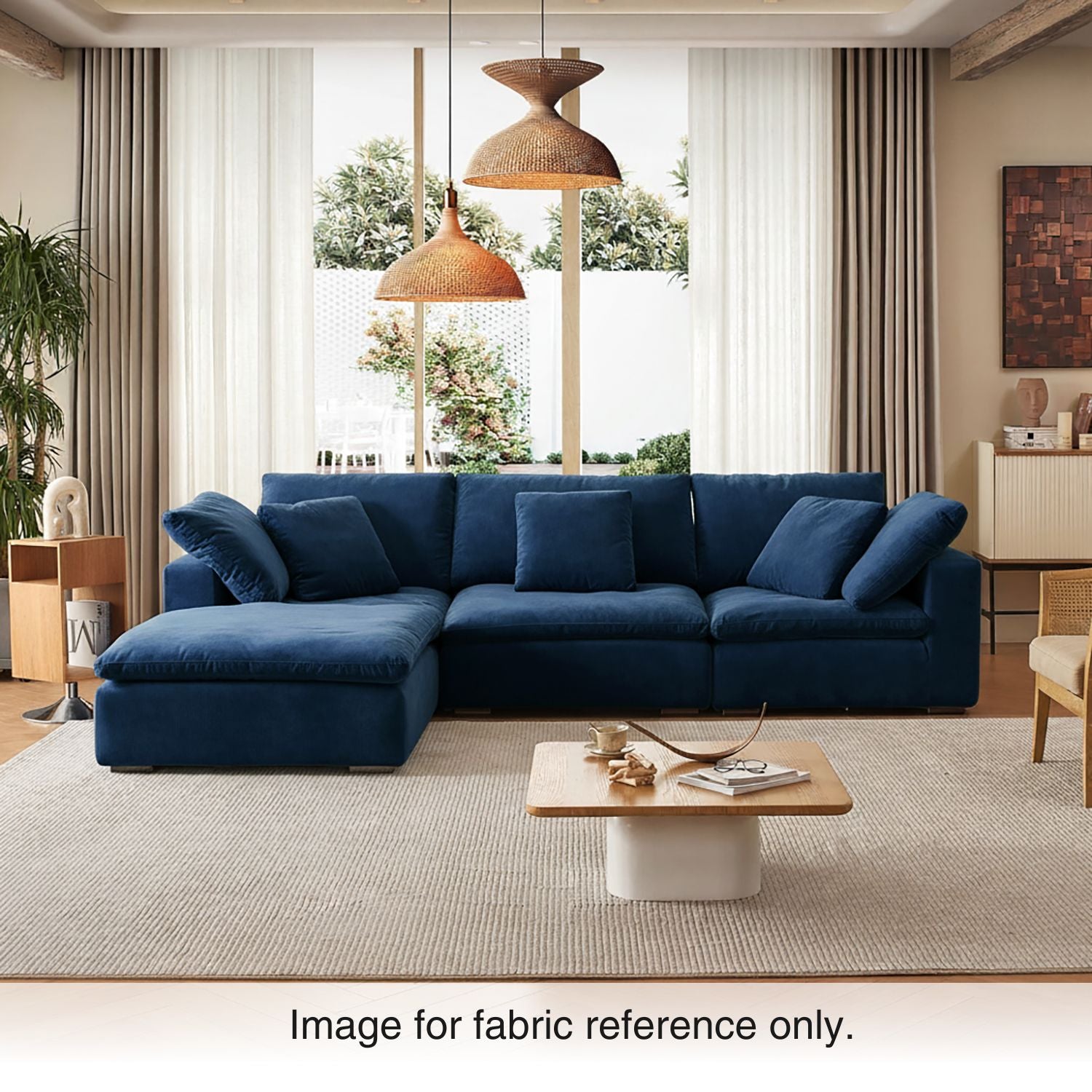 Blue velvet sectional couch with plush cushions and deep seating, styled in a contemporary living room from the Tivoli Velvet Couch Collection by Mario Capasa.
