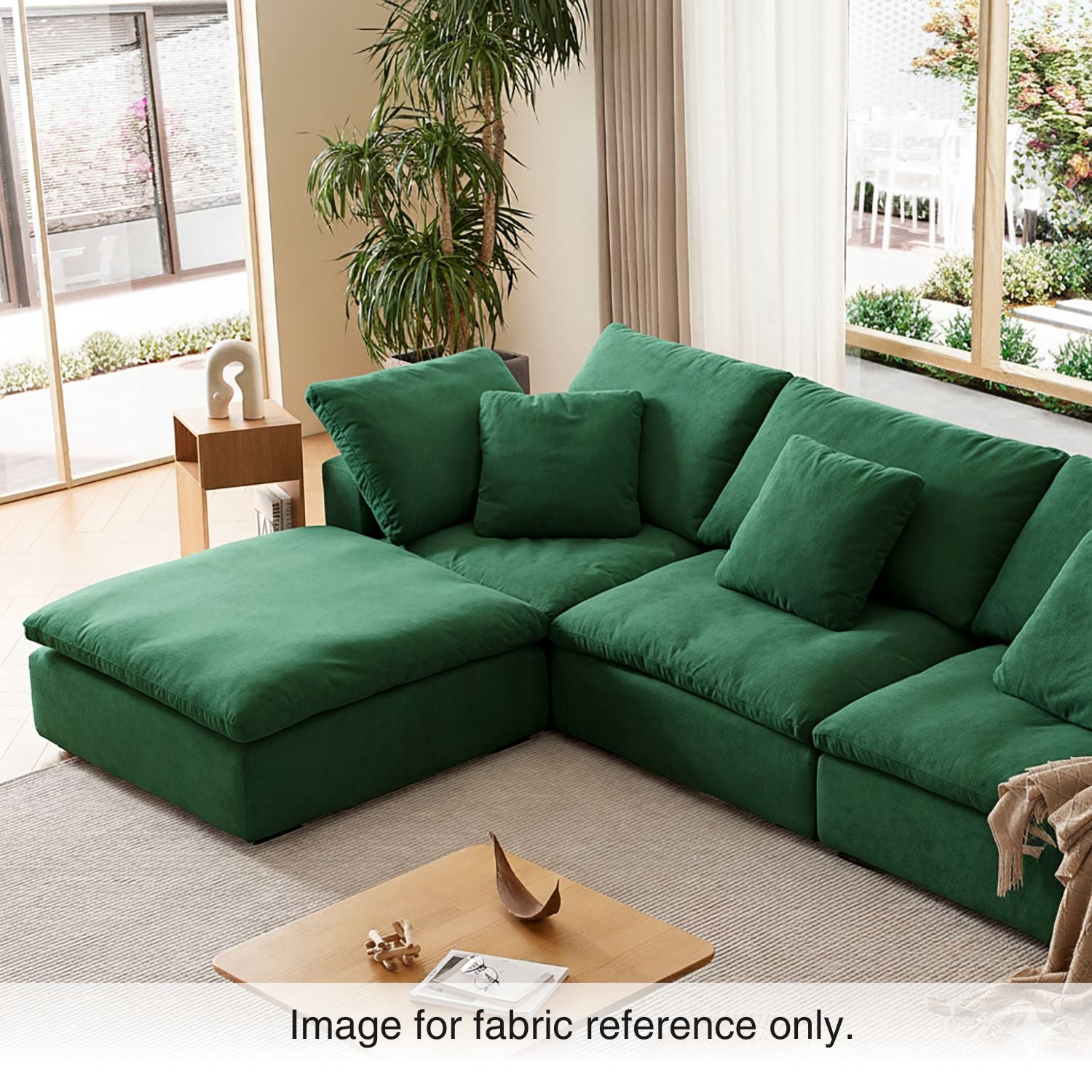 Green velvet sectional sofa in a modern living room with warm lighting, featuring plush upholstery and modular design from the Tivoli Velvet Couch Collection by Mario Capasa.