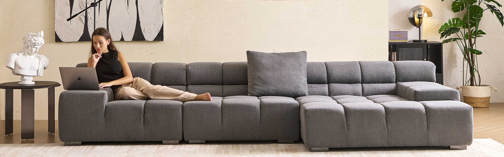 Grey sectional sofa by Mario Capasa featuring plush upholstery and deep-seat comfort for modern living room spaces.