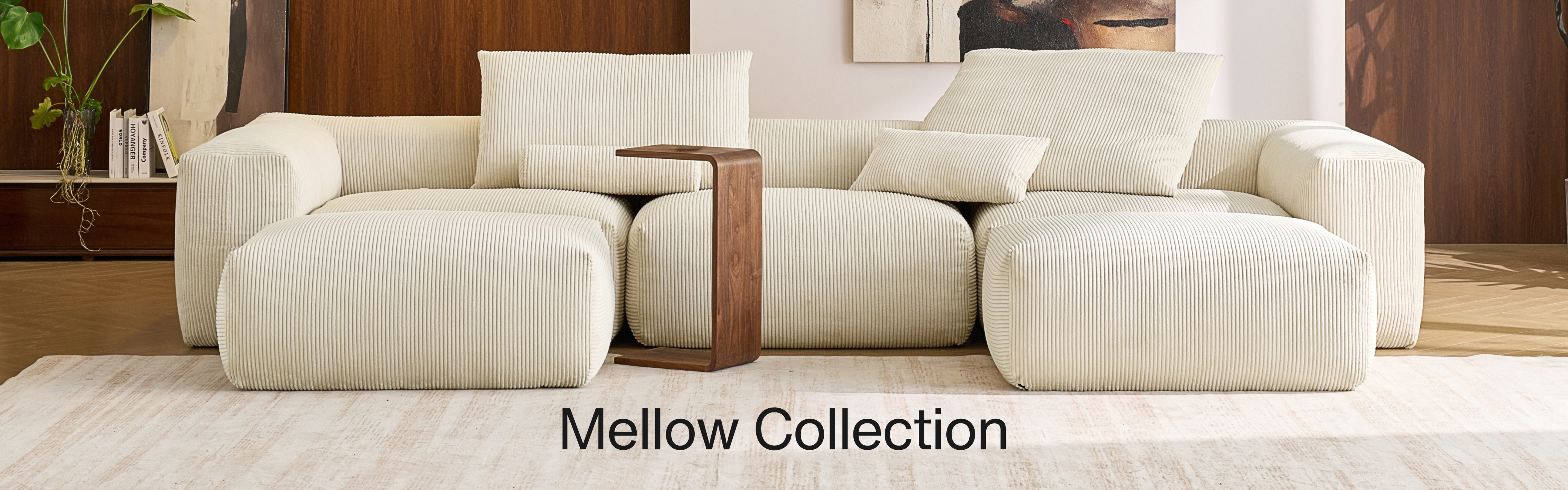 Beige deep comfortable couch by Mario Capasa with wooden side table in a living room setting, labeled 'Mellow Collection'.