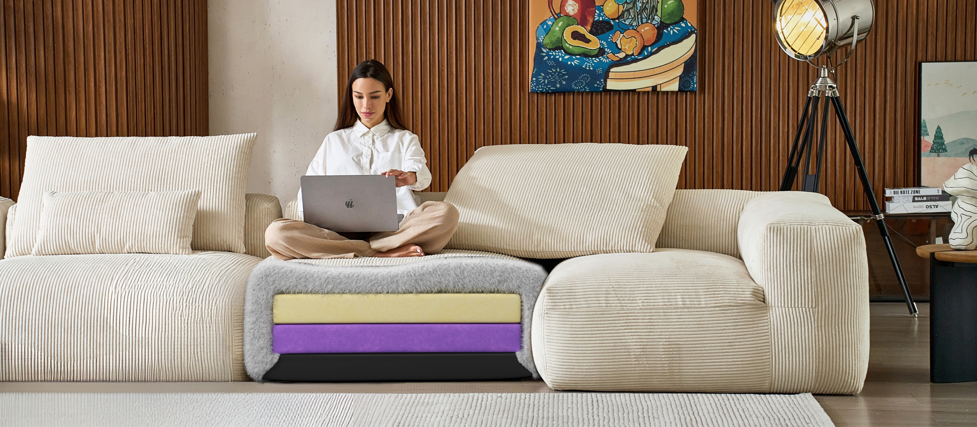 Woman using a laptop on a white corduroy cloud couch dupe by Mario Capasa.
