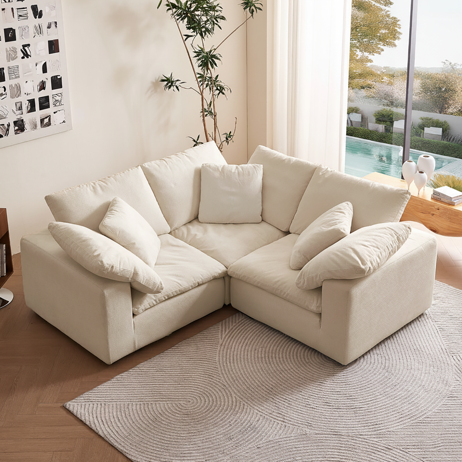 Beige sectional sofa in a living room with a pool view