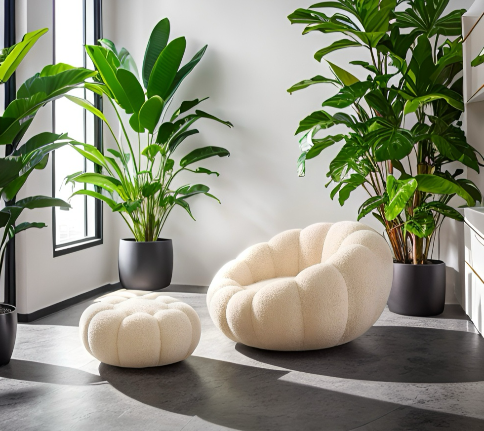 Modern interior with a cream-colored chair and ottoman, surrounded by potted plants.