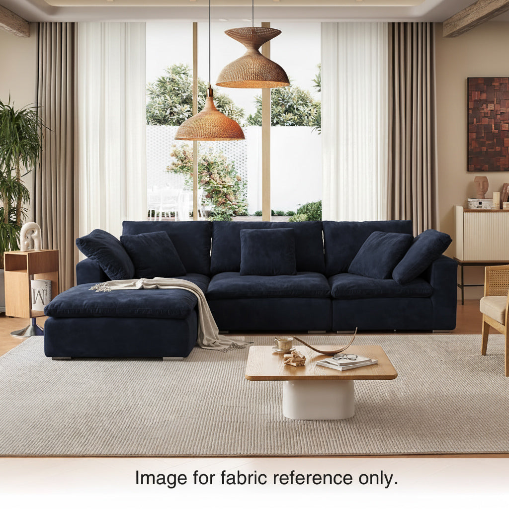 Blue velvet sectional couch with plush cushions and deep seating, styled in a contemporary living room from the Tivoli Velvet Couch Collection by Mario Capasa.