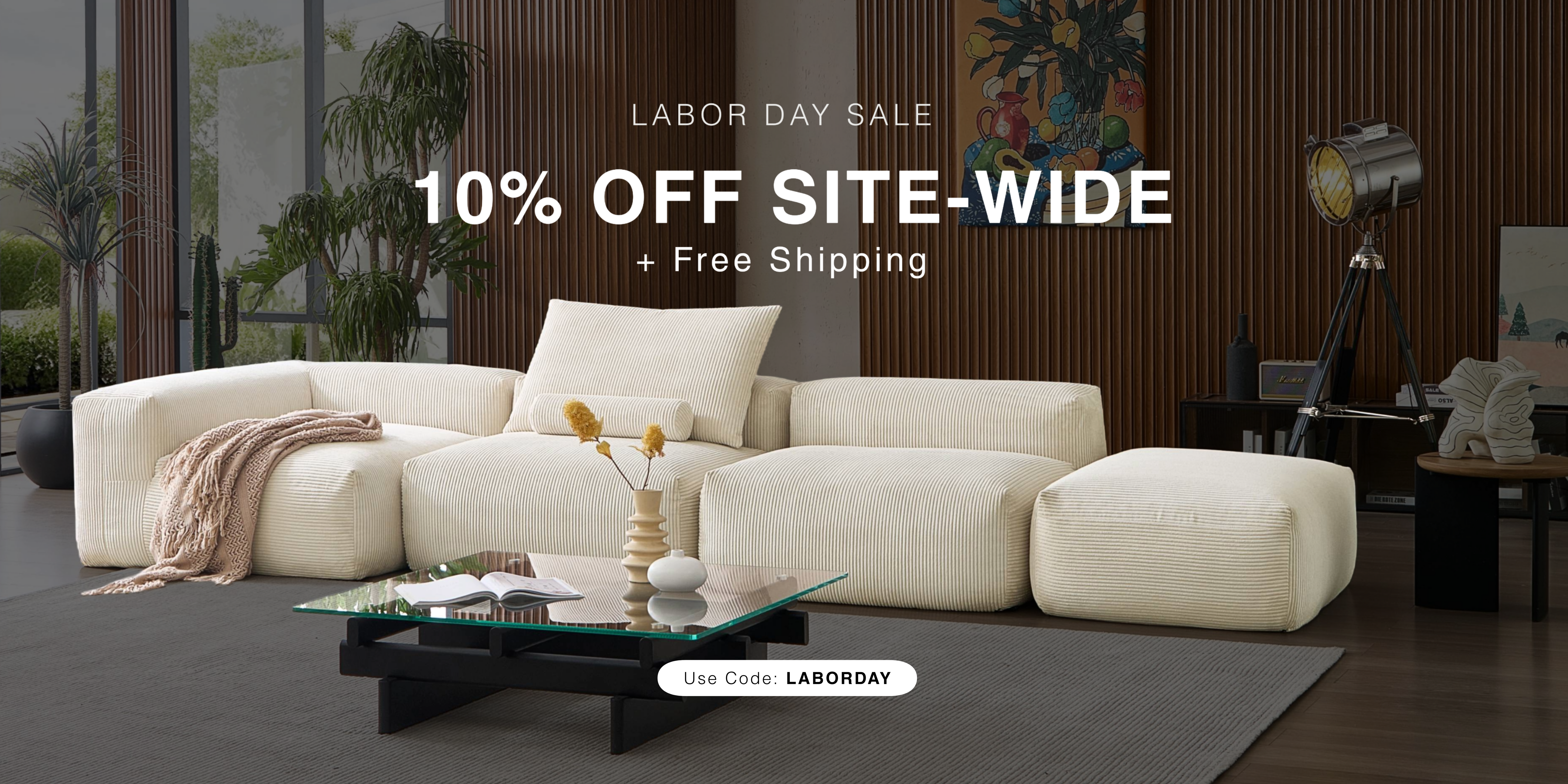 White sectional sofa in a modern living room with Labor Day sale text overlay.