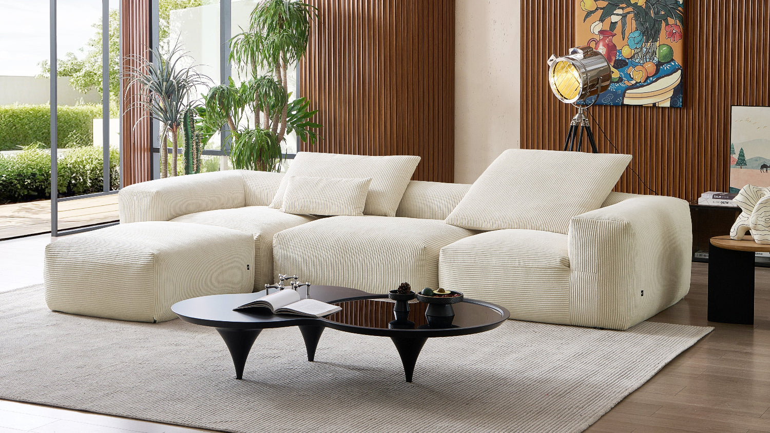 Modern living room with a white sectional sofa, coffee table, and decorative elements.