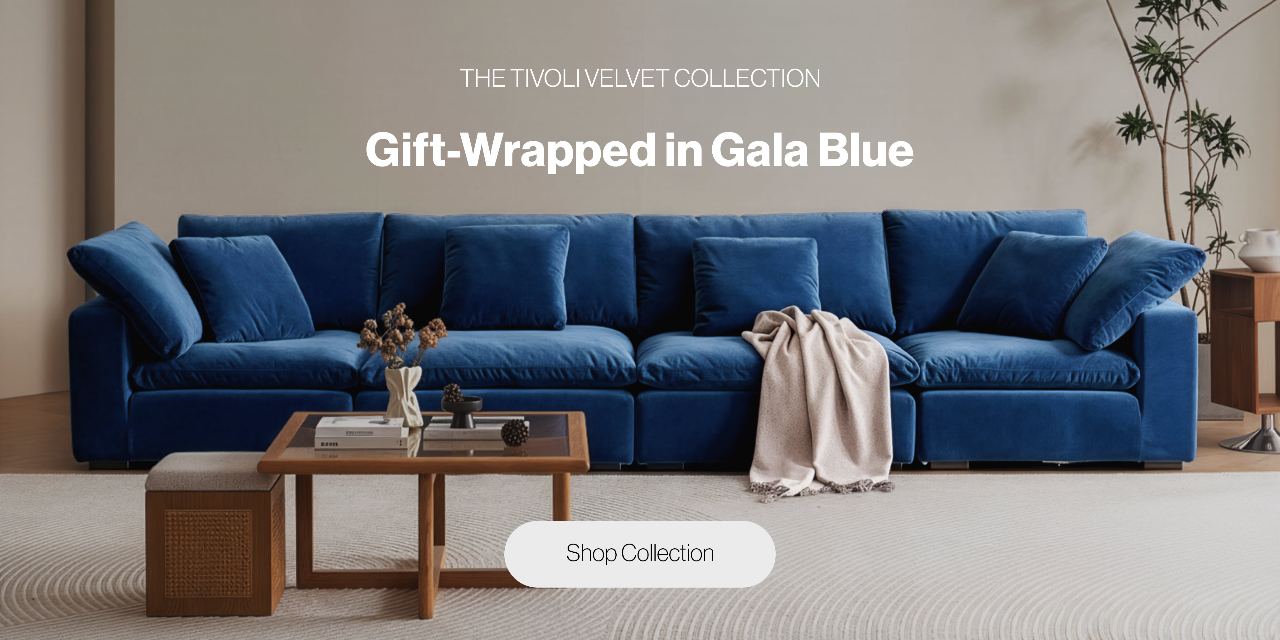 A deep blue velvet sectional sofa from Mario Capasa’s Tivoli Velvet Collection, styled in a modern living room with a wood coffee table, neutral rug, and soft natural lighting 